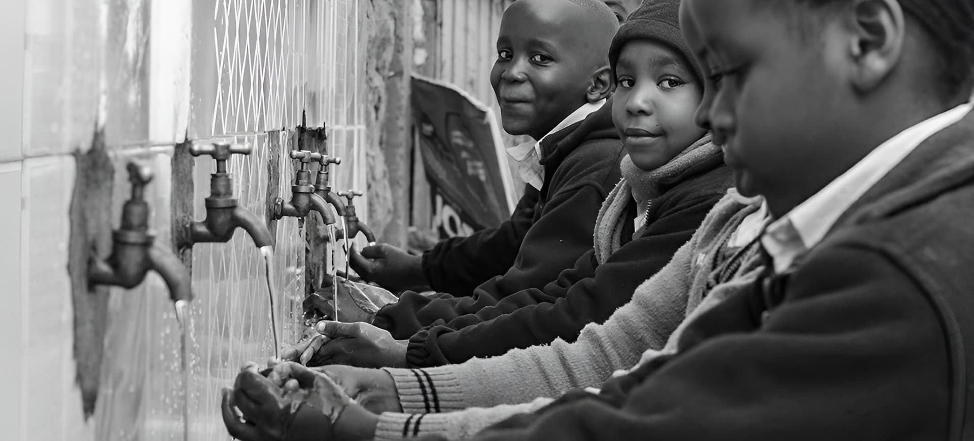 A group of children washing hands